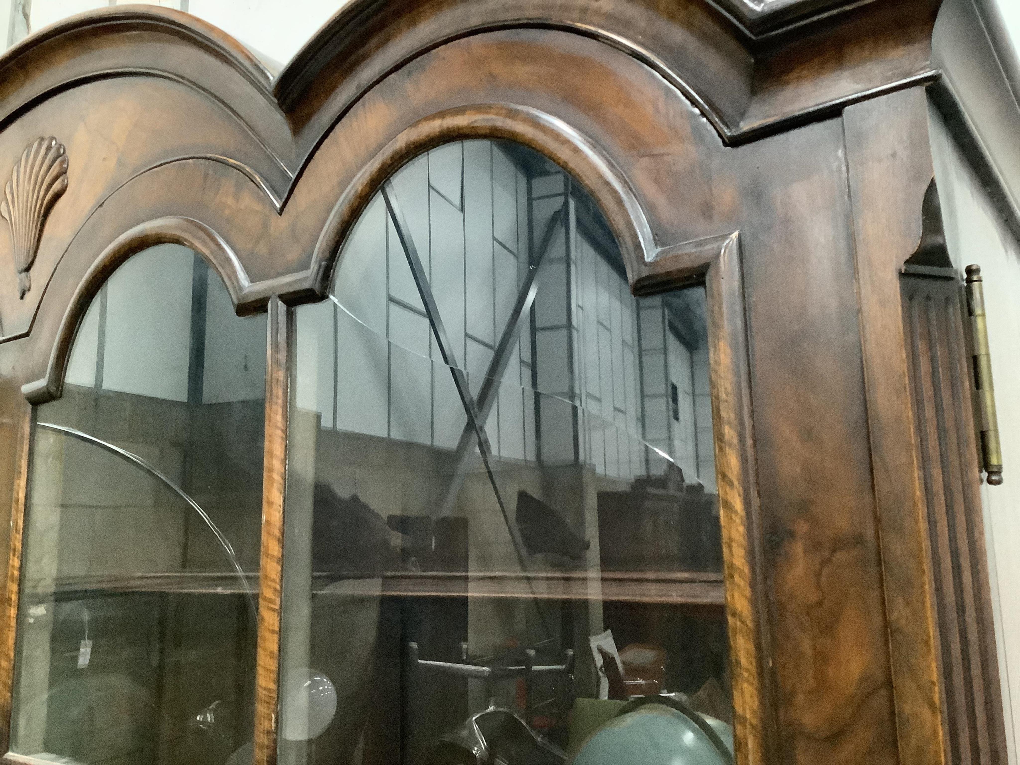 A 1930's Queen Anne Revival figured walnut bookcase, width 136cm, height 205cm. Condition - good